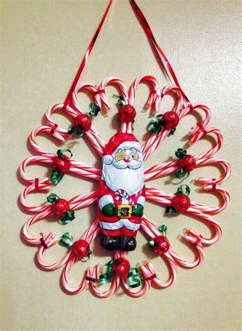 a christmas ornament hanging on a wall with candy canes