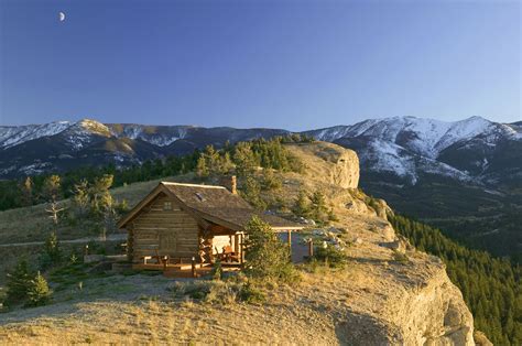 A Small Log Cabin Perched Cliffside in Montana