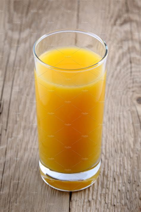 Glass of orange juice | High-Quality Food Images ~ Creative Market