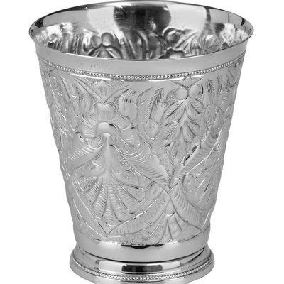 an ornate silver cup on a white background