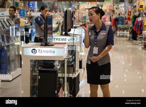 A Filipino employee sings on Karaoke machine in Cebu City mall Stock ...