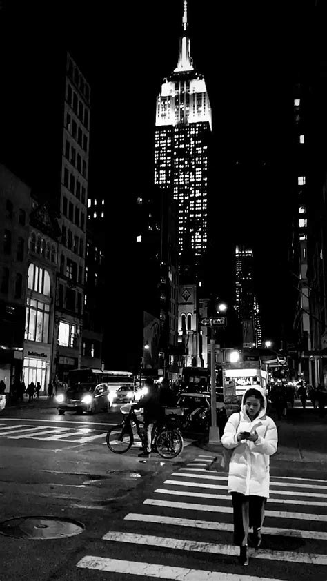 black and white photograph of a woman crossing the street in new york ...