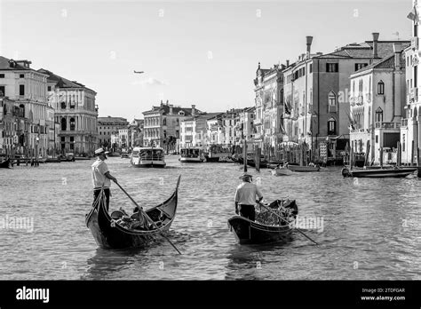 Two gondoliers cross the famous Grand Canal in Venice, Italy, in black and white Stock Photo - Alamy