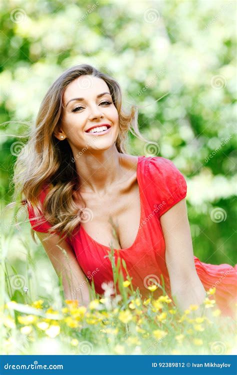 Woman in Red Dress Sitting on Grass Stock Photo - Image of portrait, happiness: 92389812