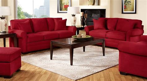 a living room with red couches and chairs