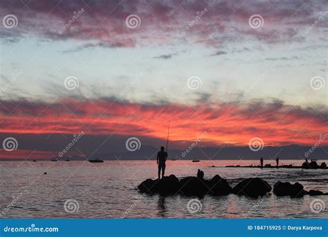 Man Fishing at Sunset in the Sea. Silhouette Stock Image - Image of ...