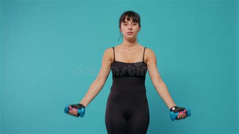 Fit Woman Lifting Dumbbells To Train Arms Muscles in Front of Camera Stock Video - Video of ...