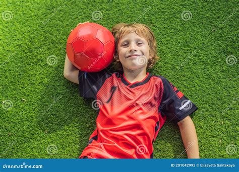 Little Cute Kid Boy in Red Football Uniform Playing Soccer, Football on ...