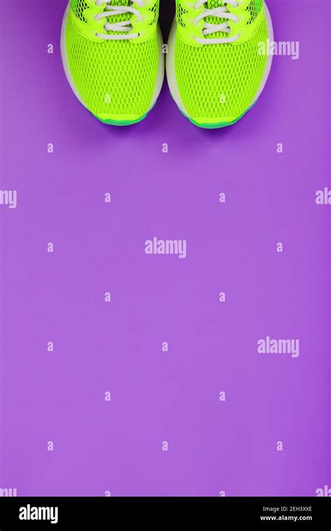 Green running shoes on a purple background. Top view, free space Stock Photo - Alamy