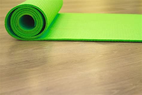 Yoga mat on wooden floor stock photo. Image of club - 103625190