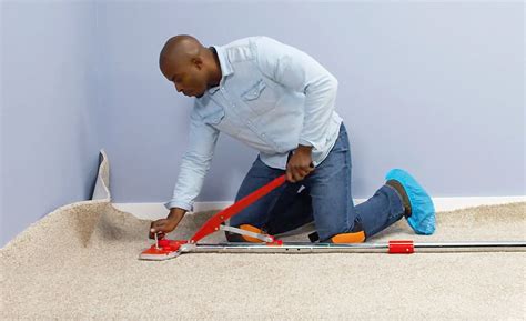 A person using a power stretcher for carpet installation. | Carpet installation, Carpet ...