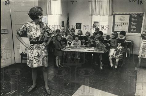 Mrs. Lind shows dress she sewed to St. Andrew Episcopal School kids ...