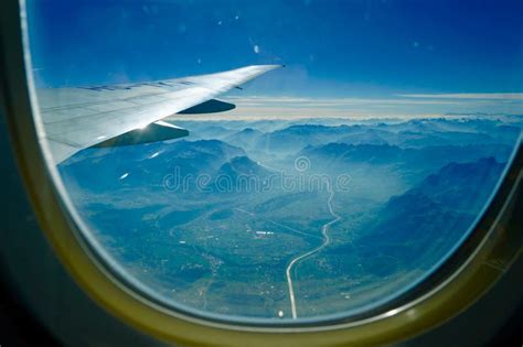 View of Mountains and Valley from Airplane Window Stock Photo - Image ...