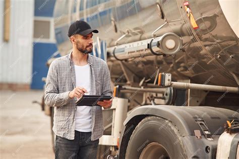 Premium Photo | Using tablet young truck driver in casual clothes