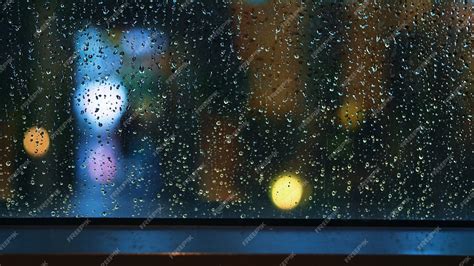 Premium Photo | Rain drop on window at night. Condominium or apartment living room window on ...