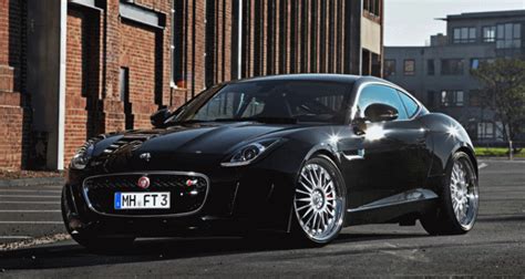 a black sports car parked in front of a brick building