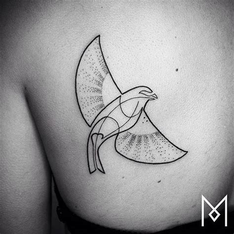 Continuous line bird tattoo on the left shoulder blade.