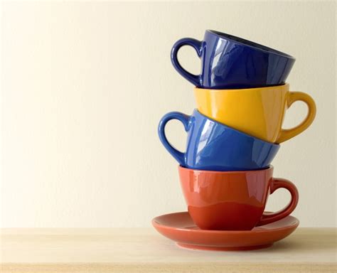 Free Photo | Stack of colorful coffee cups on table