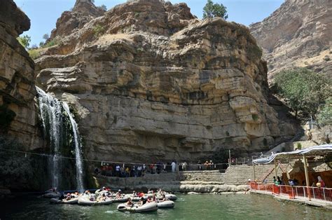 people are rafting in the water near a waterfall