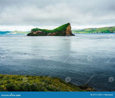 Scenic Landscape Featuring a Small Island Covered with Lush Green Grass ...