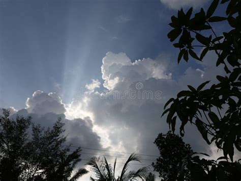 Afternoon Sun Rays Behind the Clouds on a Blue Sky Background Stock Photo - Image of clouds ...