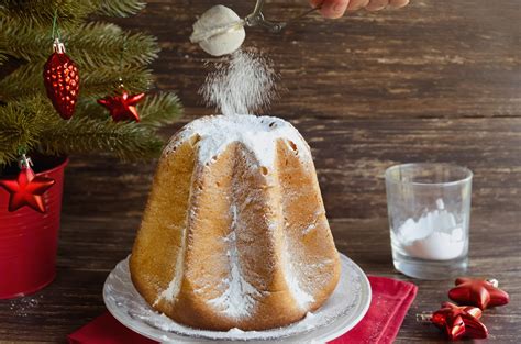 Delicious Christmas cake Pandoro with vanilla scente icing sugar traditiolly consumed at ...