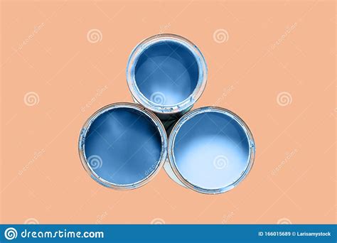 Three Cans Filled Paint of Classic Blue Color Isolated on Peach Quartz Trendy Color Background ...