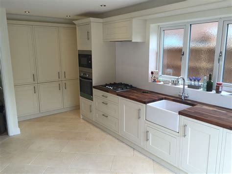 Lovely cream painted oak shaker style kitchen with walnut work tops. Buffed limestone floor ...