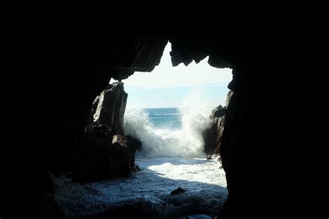 sea waves splashing at the entrance to a dark sea cave, sea cave ...