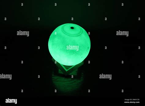 Complex moon lamp that has different colors concepts.This lamp also has a brown support that ...