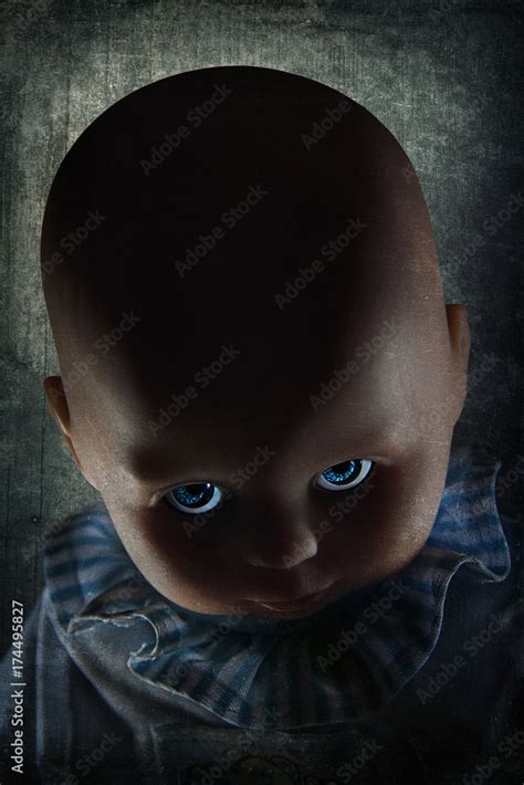 Creepy looking doll with blue eyes with dramatic lighting and textured background. Stock Photo ...