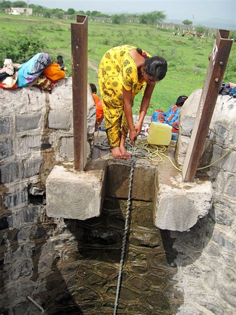 Stock Pictures: Women filling water from village well in India