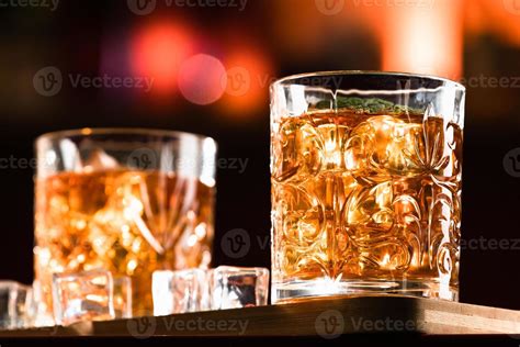 Whiskey Drinks with ice in a lounge bar 3956570 Stock Photo at Vecteezy