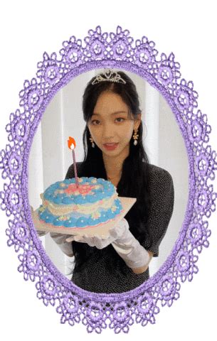 a woman holding a cake with a candle in it