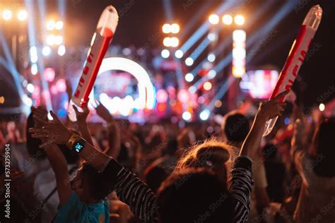 Crowd of hands up concert stage lights and people fan audience ...