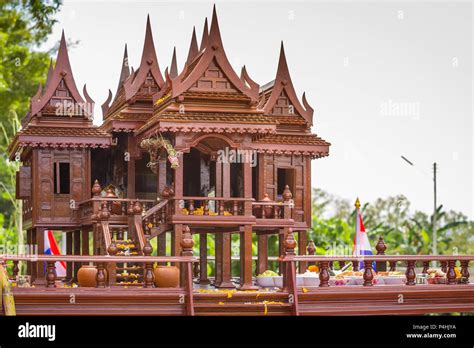 Beautiful Thai style spirit house or house of the guardian spirit is made of wood and sculptured ...