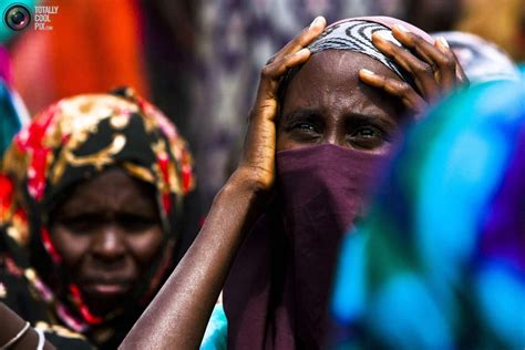 Newly arrived Somali refugees sit in the open as they await medical ...