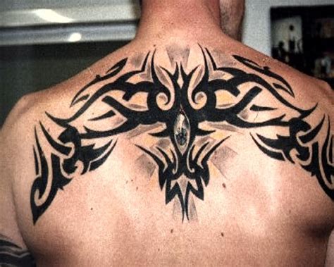 Black Tribal Design Tattoo On Man Upper Back