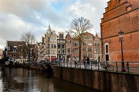 Premium Photo | A canal in amsterdam with a bridge and a building in ...