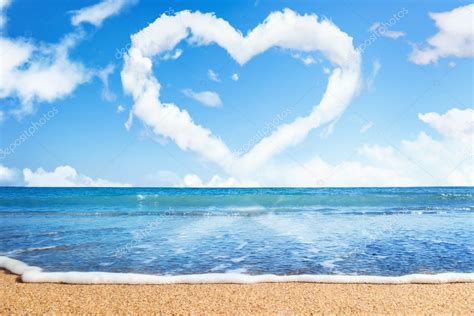 Beach and sea. Heart of clouds on sky. Symbol of love — Stock Photo ...