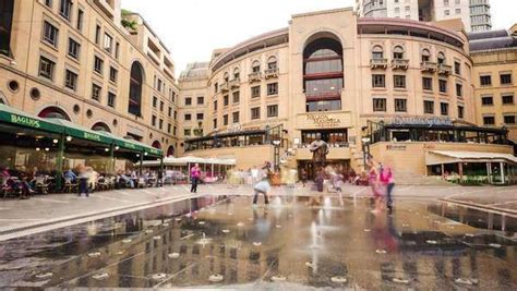 People and children having fun and eating at restaurants at Nelson Mandela Square in Sandton ...