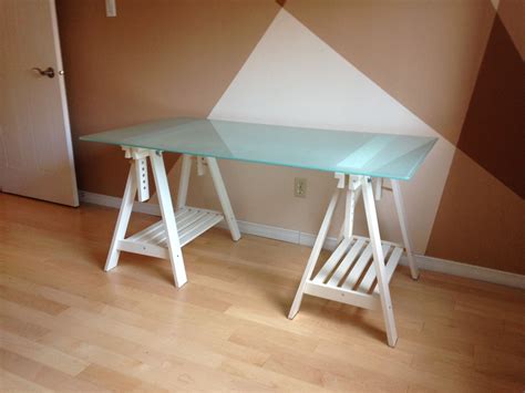 IKEA Glass desk top with adjustable white trestle legs. IKEA GLASHOLM glass table top (58 1/4x28 ...