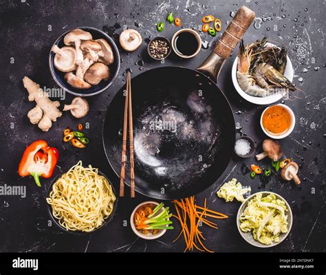 Asian food cooking concept. Empty wok pan, noodles, vegetables stir fry ...