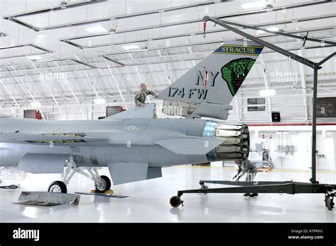 New York Air National Guard Airmen assigned to the 174th Attack Wing dismantle an F-16 Fighting ...