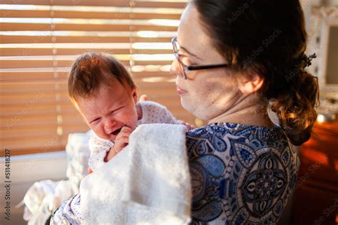 Young mother comforting sad crying baby child Stock Photo | Adobe Stock