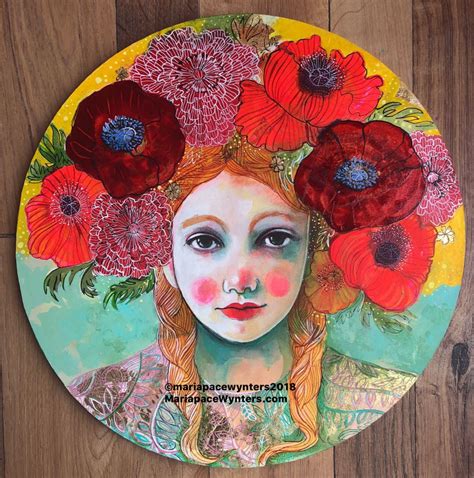 a painting of a woman with flowers in her hair on a round plate sitting on a wooden floor