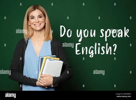 Beautiful English teacher with books near chalkboard Stock Photo - Alamy