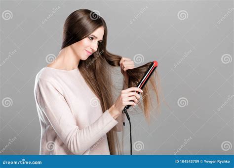 Woman Ironing Hair with Hair Iron. Stock Image - Image of beauty, care ...