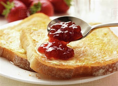 Toast with butter and strawberry jam - Stock Photo - Dissolve