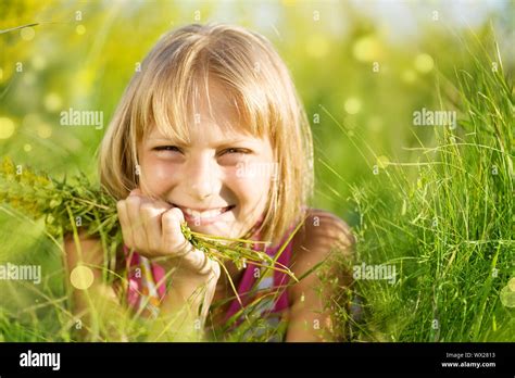 Beautiful Summer Portrait Of Little Girl In The Grass Stock Photo - Alamy